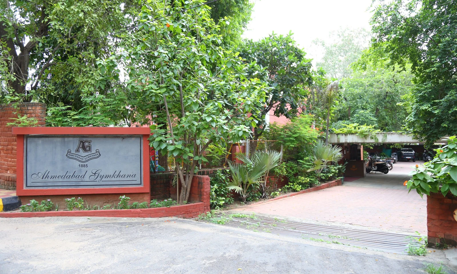 Ahmedabad Gymkhana entrance sign and tree-lined driveway