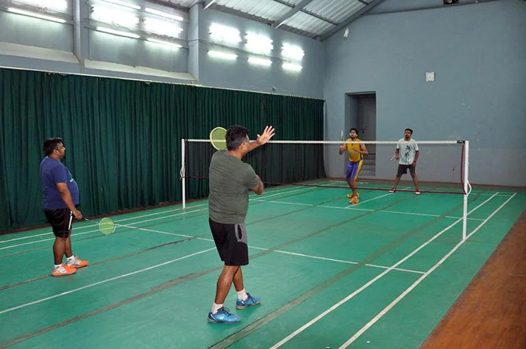 Indoor badminton court in use at Cuttack Club