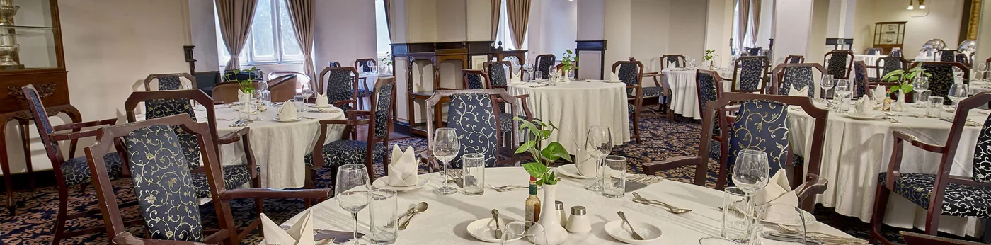 Dining room set for service at The Bengal Club