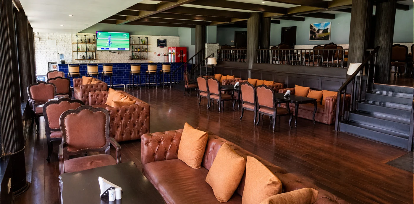 Indoor lounge and bar at The Poona Club